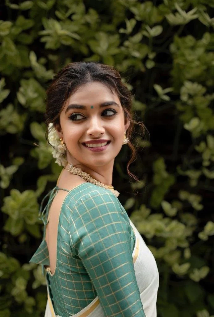 A woman wearing a blue blouse and gold earrings photo – Free India Image on  Unsplash