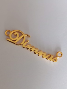 gold pendant with the name Dimnas