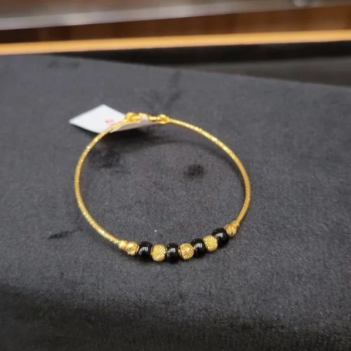 Gold Bangle with a mix of black beads
